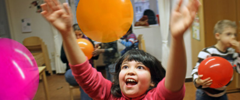 Finkenkrug Schule Kind spielt strahlend mit Luftballons Finkenkrug Schule Kind spielt strahlend mit Luftballons
